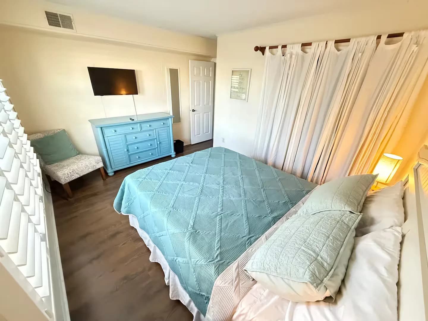 Queen bedroom with room-darkening shades and its own TV
